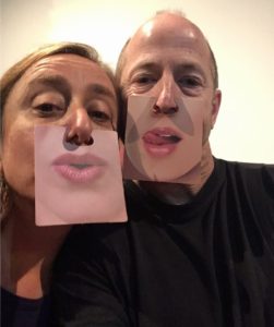 Playful duo wearing photo masks to change their lips.